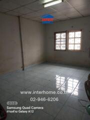 Empty room with tiled floor and barred windows