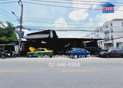 Street view of a building with vehicles parked in front