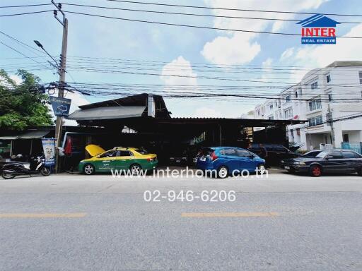 Street view of a building with vehicles parked in front