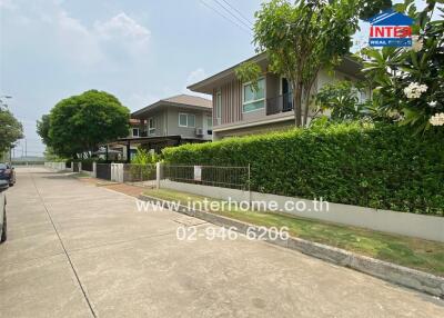 Exterior view of residential buildings with greenery and driveway