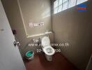 Small bathroom with a glass block window and toilet