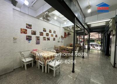 A dining area in a commercial space with tables and chairs.