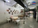 A dining area in a commercial space with tables and chairs.