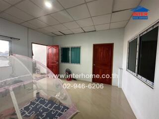 Bedroom with tile flooring, multiple doors and windows, and a fan