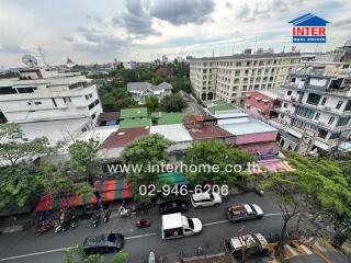 High view of cityscape with various buildings and a busy street