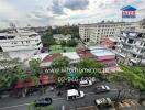 High view of cityscape with various buildings and a busy street