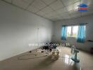 Empty bedroom with tiled floor, window, and ceiling fan