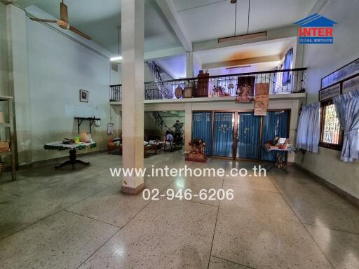 Spacious main living area with high ceilings and balcony