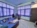 Bedroom with blue curtains and air conditioning