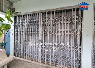 Front view of a secured building entrance with metal gates