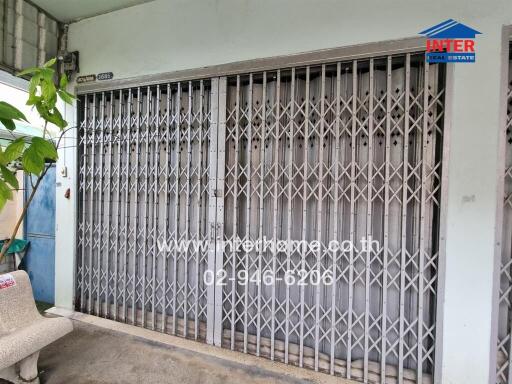 Front view of a secured building entrance with metal gates