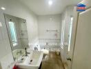 Modern white-tiled bathroom with shower and sink