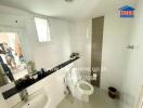 Modern bathroom with white tiling and a large mirror