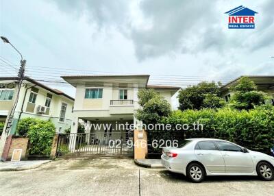 Front view of a residential house with a car parked in the driveway