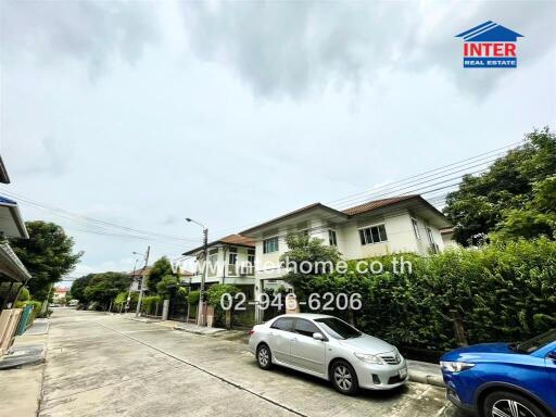 Residential street with houses and parked cars