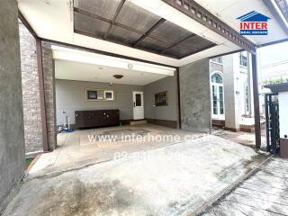 Covered garage space with storage area and entrance to the house