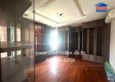 Spacious bedroom with wooden flooring, built-in wardrobe and natural light