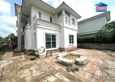 Exterior view of a two-story house with backyard