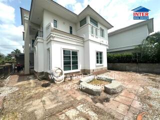 Exterior view of a two-story house with backyard