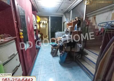 Indoor hallway or storage area with various items and blue-tiled floor