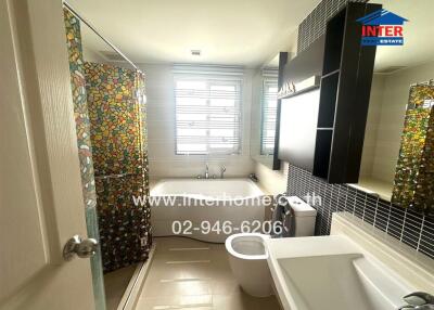 Modern bathroom with colorful tiled shower