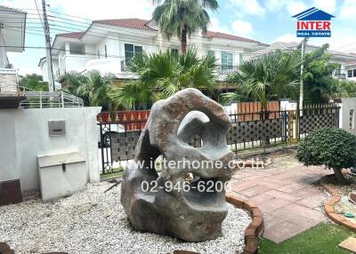 Outdoor garden with large stone sculpture