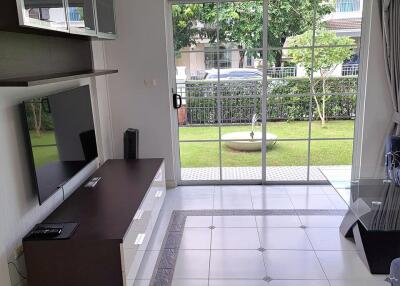 Modern living room with TV stand and sliding glass doors