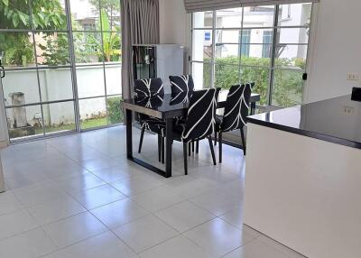 Modern dining area with large windows and garden view