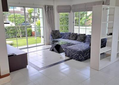 Spacious and bright living room with glass doors leading to the garden