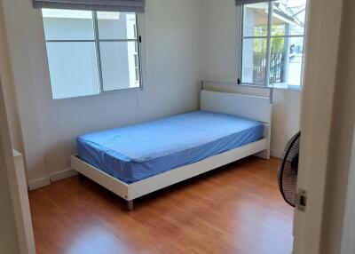 Bedroom with single bed and wooden floor