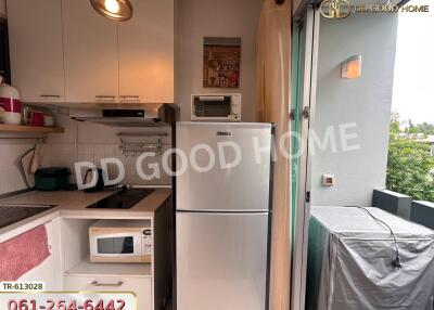 Compact kitchen with appliances and balcony access