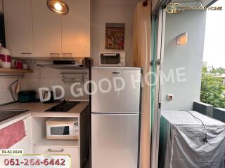 Compact kitchen with appliances and balcony access