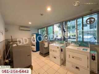 Spacious laundry room with washers and dryers