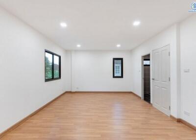 Spacious main living area with wooden flooring and recessed lighting