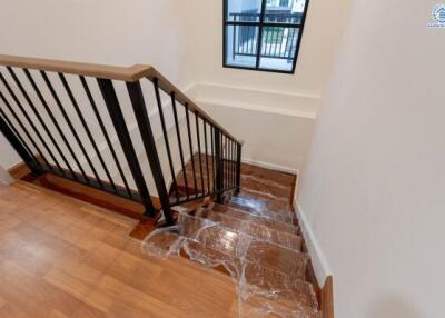 Staircase with wooden steps and black metal railings