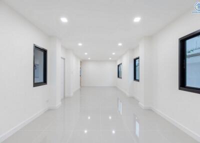 Spacious modern living room with white walls and glossy tiled floor