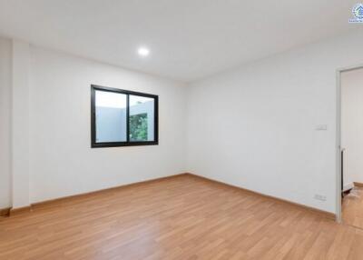 Empty bedroom with wooden flooring and window