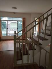 Staircase view in a bright living area with large windows