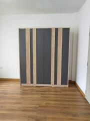 Bedroom with wooden wardrobe and floor