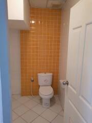 Bathroom with orange tiled wall and white fixtures