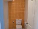 Bathroom with orange tiled wall and white fixtures