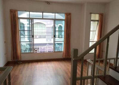 Living room with large window and wooden floor