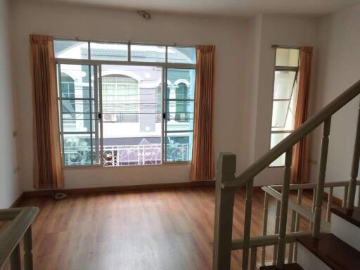 Living room with large window and wooden floor