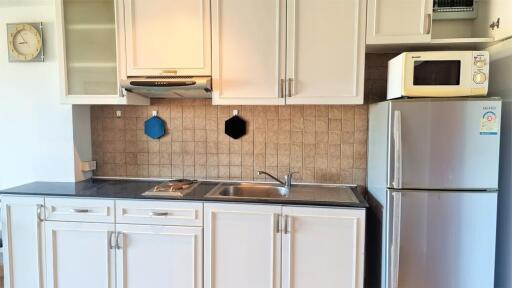 Modern kitchen with cabinets, sink, stove, and refrigerator