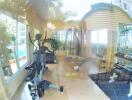 bright modern fitness center with exercise equipment and large windows