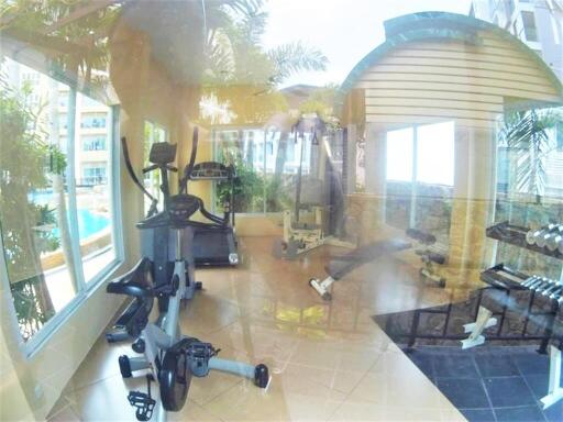 bright modern fitness center with exercise equipment and large windows