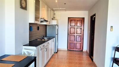 Simple kitchen area with essential appliances