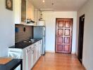 Simple kitchen area with essential appliances