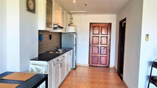 Simple kitchen area with essential appliances