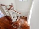 Staircase with wooden steps and white railings